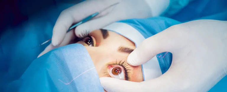 An eye surgeon examining a patient's eye with medical equipment.