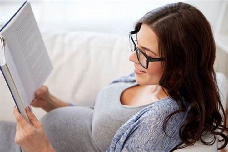 A woman holding her pregnant belly, representing pregnancy after undergoing Lasik surgery.