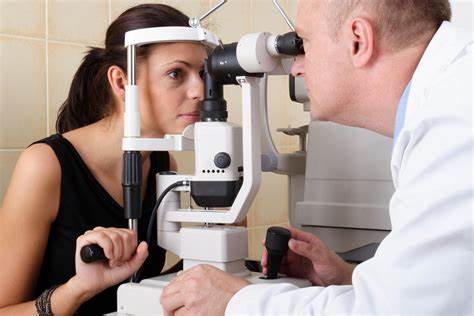 A woman sitting at a desk with paperwork, preparing for a LASIK consultation.